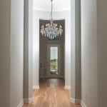 Wire-Brushed Natural Hickory Wood Flooring in Hallway with Crystal Chandalier