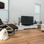 Wire-Brushed Natural Hickory Wood Flooring in Living Room with dogs and flatscreen
