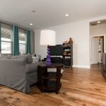 Champagne Hickory Wood Flooring in Living Room with grey couch